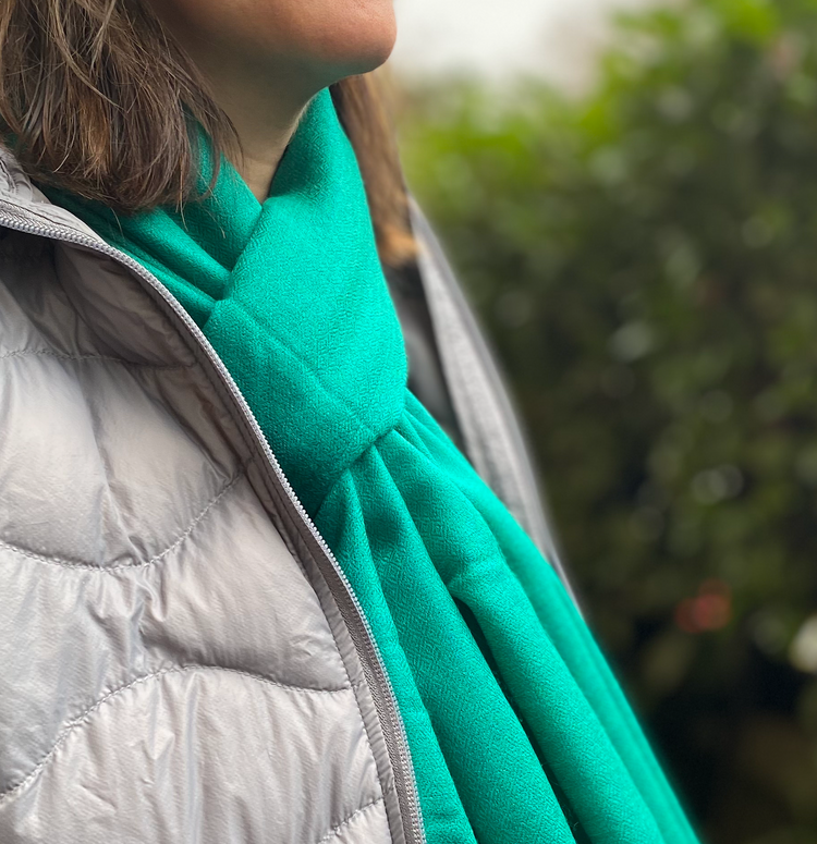 Woman showcasing the 'Eye of the Nightingale' cashmere-silk blend stole by Laal, with its subtle diamond weave and nuanced sheen, crafted by Kashmiri artisans for timeless elegance and comfort.