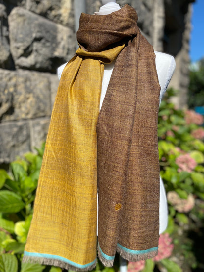 Laal's Signature Reversible Pashmina Stole, a fusion of historic elegance and luxury from the valleys of Kashmir. Crafted from 100% pure cashmere since the 1860s, these stoles are light yet insulating, perfect for various settings from city chic to casual gatherings. Available in six color combinations, each piece reflects the beauty of the Himalayas. Meticulously woven by artisans from Srinagar