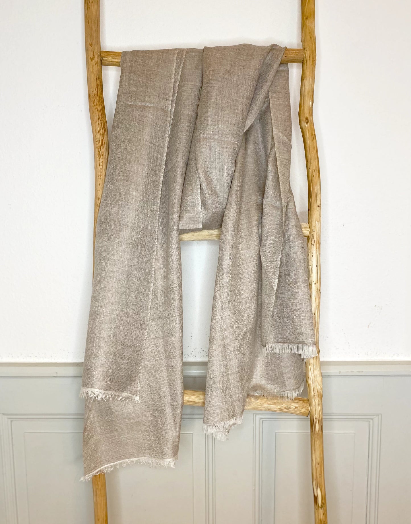 This classic stole is handwoven with 100% cashmere by skilled Kashmiri artisans using traditional looms in Srinagar, India. The stole is lightweight, soft and incredibly delicate and thin.