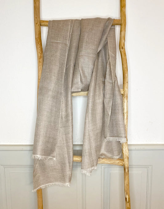 This classic stole is handwoven with 100% cashmere by skilled Kashmiri artisans using traditional looms in Srinagar, India. The stole is lightweight, soft and incredibly delicate and thin.