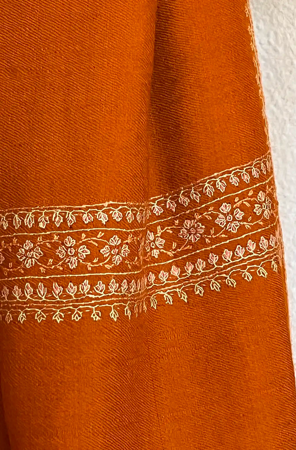 Pashmina stole in burnt orange with light border embroidery