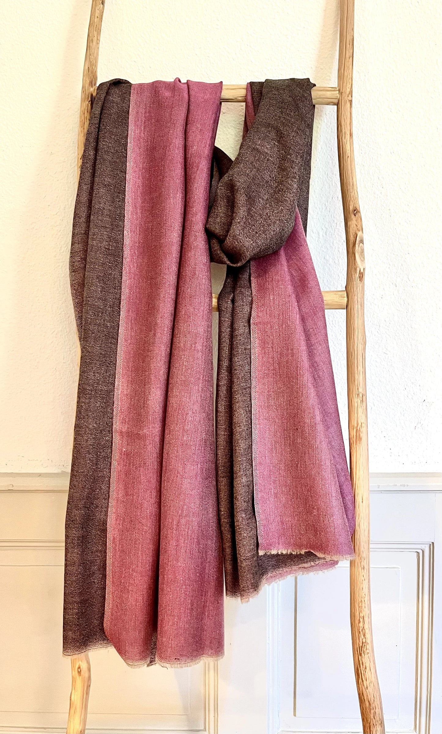 Since the 1860s, the reversible "dorukha" Pashmina stoles have been a beloved product of Kashmir. This double-sided stole, made from 100% cashmere, is light, soft, and exquisite. It is hand-woven on a traditional loom and is a popular choice for both men and women. The classic Pashmina is one of our best sellers, ideal for semi-casual occasions, city dressing, and winter days in the mountains.