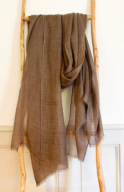 Laal's Pure Baby Pashmina Shawl, embodying luxury with its ultra-soft, lightweight, and breathable baby cashmere. Crafted from first-combed baby goat fibers, it features a delicate weave in five natural cashmere colors. Handspun and woven in Kathmandu, this oversized, unisex shawl with eyelash fringes is versatile for autumn, winter, and spring. Warm, comfortable, and itch-free, it's an ideal gift for any occasion.