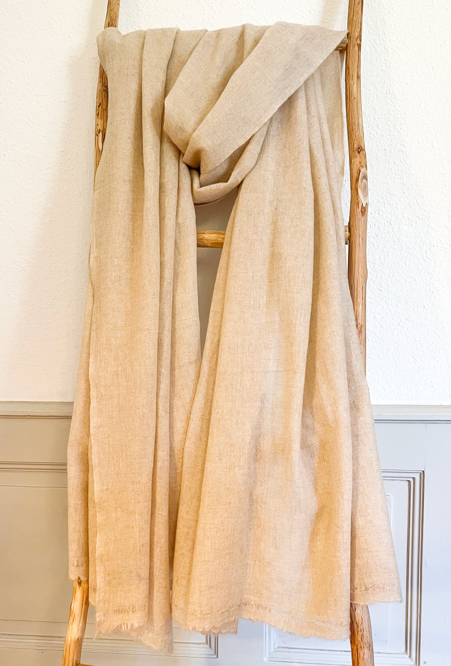 Laal's Pure Natural Cashmere Shawl, a symbol of sustainable luxury and elegance. Handwoven in Kathmandu from 100% premium, undyed cashmere, this environmentally friendly shawl is soft, warm, and comfortable. Its generous size allows for versatile styling, perfect for cold weather. Timeless in design, it's an excellent long-term addition to your wardrobe, offering both warmth and sophistication.