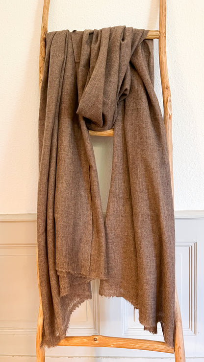 Laal's Pure Natural Cashmere Shawl, a symbol of sustainable luxury and elegance. Handwoven in Kathmandu from 100% premium, undyed cashmere, this environmentally friendly shawl is soft, warm, and comfortable. Its generous size allows for versatile styling, perfect for cold weather. Timeless in design, it's an excellent long-term addition to your wardrobe, offering both warmth and sophistication.