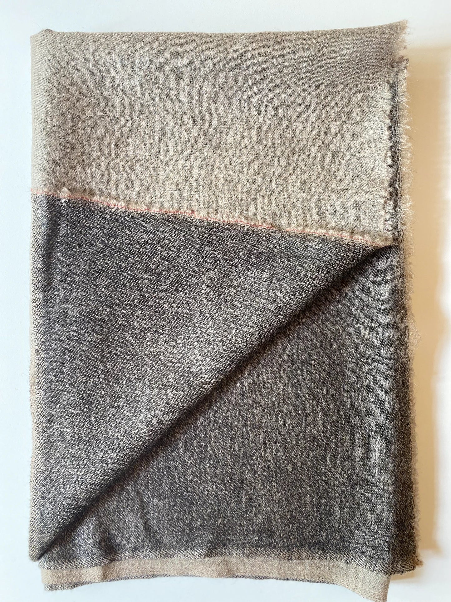 Since the 1860s, the reversible "dorukha" Pashmina stoles have been a beloved product of Kashmir. This double-sided stole, made from 100% cashmere, is light, soft, and exquisite. It is hand-woven on a traditional loom and is a popular choice for both men and women. The classic Pashmina is one of our best sellers, ideal for semi-casual occasions, city dressing, and winter days in the mountains.