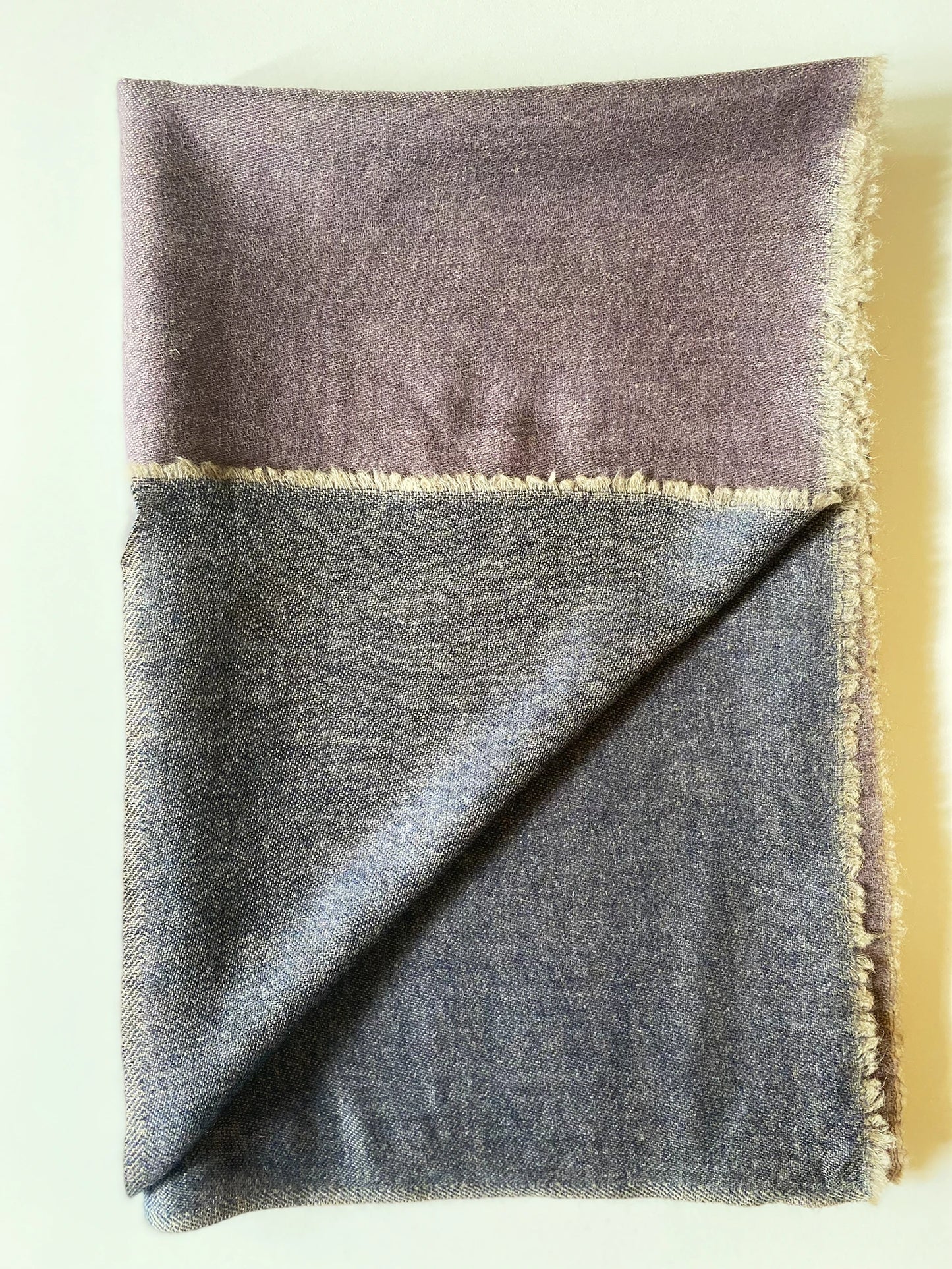 Since the 1860s, the reversible "dorukha" Pashmina stoles have been a beloved product of Kashmir. This double-sided stole, made from 100% cashmere, is light, soft, and exquisite. It is hand-woven on a traditional loom and is a popular choice for both men and women. The classic Pashmina is one of our best sellers, ideal for semi-casual occasions, city dressing, and winter days in the mountains.