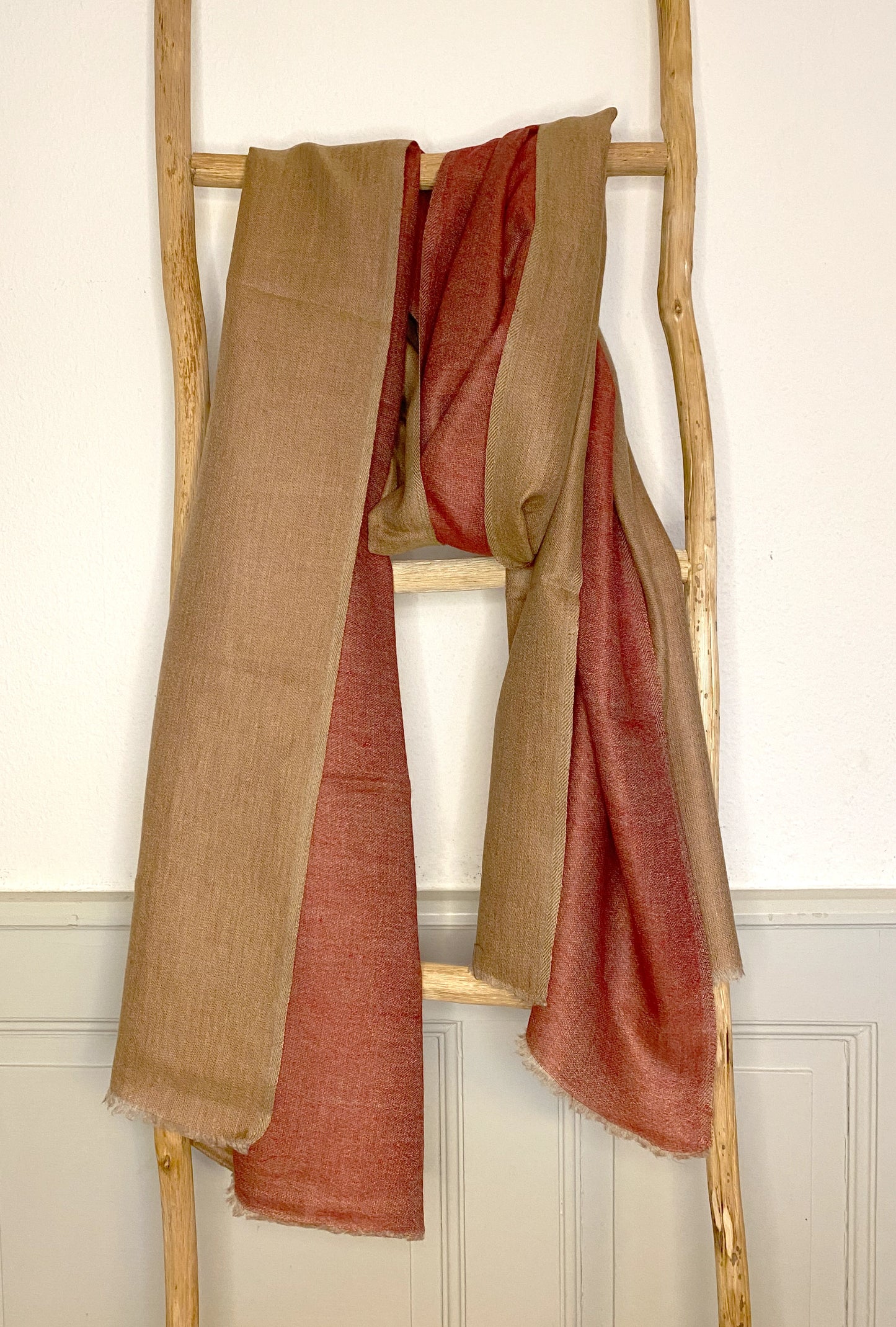 Since the 1860s, the reversible "dorukha" Pashmina stoles have been a beloved product of Kashmir. This double-sided stole, made from 100% cashmere, is light, soft, and exquisite. It is hand-woven on a traditional loom and is a popular choice for both men and women. The classic Pashmina is one of our best sellers, ideal for semi-casual occasions, city dressing, and winter days in the mountains.
