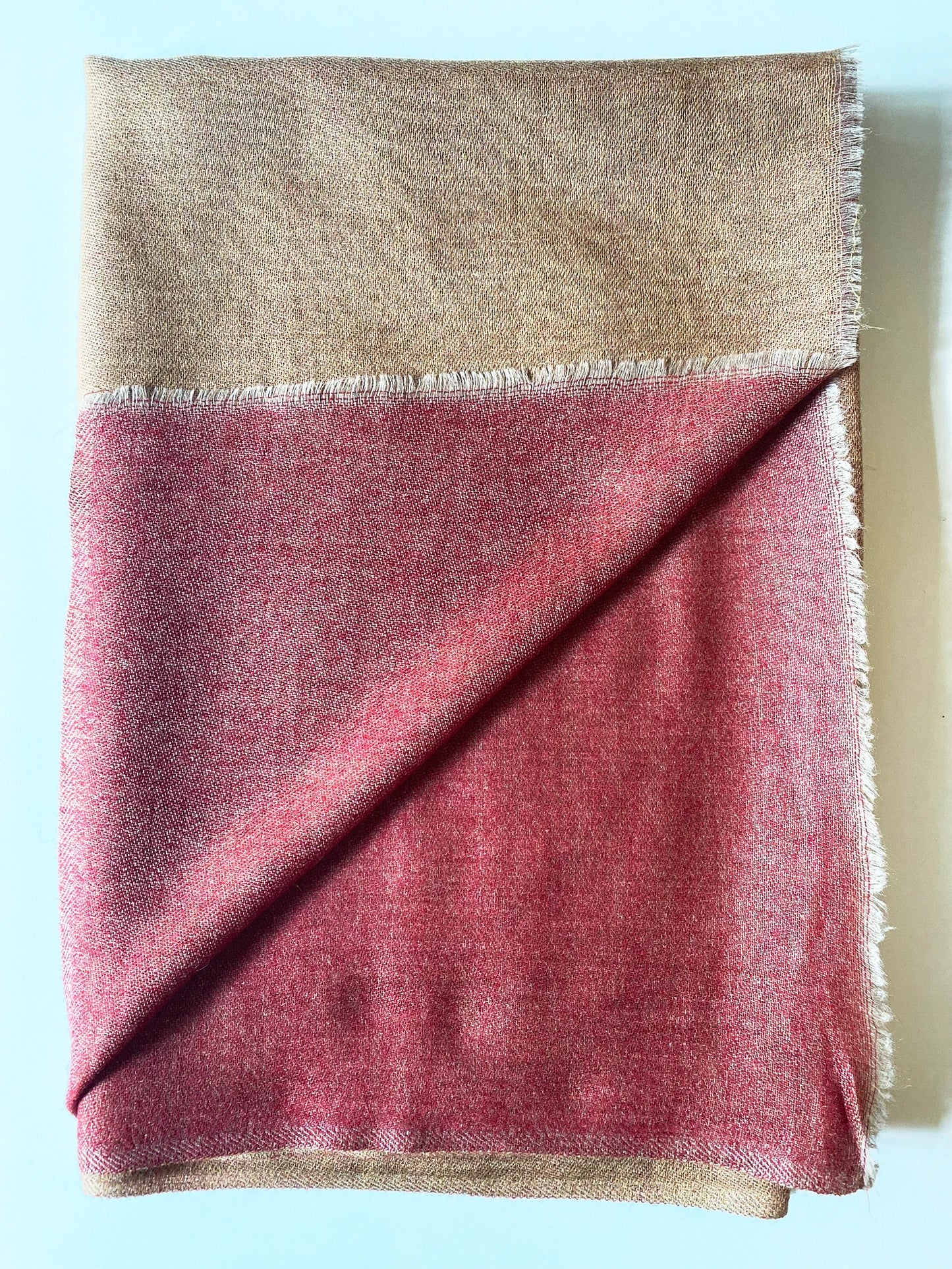 Since the 1860s, the reversible "dorukha" Pashmina stoles have been a beloved product of Kashmir. This double-sided stole, made from 100% cashmere, is light, soft, and exquisite. It is hand-woven on a traditional loom and is a popular choice for both men and women. The classic Pashmina is one of our best sellers, ideal for semi-casual occasions, city dressing, and winter days in the mountains.