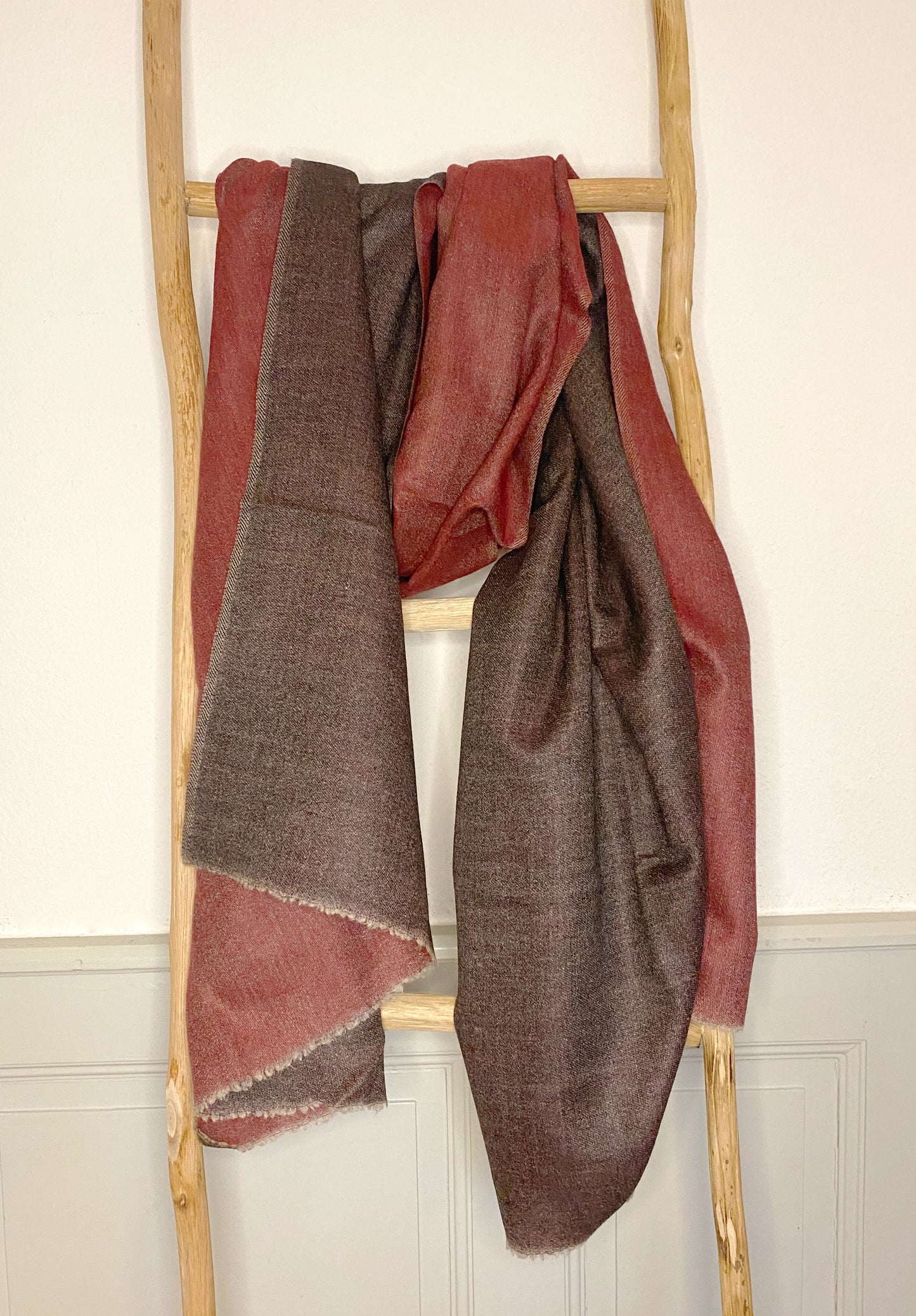 Since the 1860s, the reversible "dorukha" Pashmina stoles have been a beloved product of Kashmir. This double-sided stole, made from 100% cashmere, is light, soft, and exquisite. It is hand-woven on a traditional loom and is a popular choice for both men and women. The classic Pashmina is one of our best sellers, ideal for semi-casual occasions, city dressing, and winter days in the mountains.
