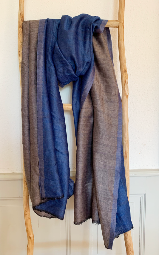 Laal's Reversible Pashmina Stole, a 'dorukha' design dating back to the 1860s in Kashmir. This lightweight, soft, double-sided stole is versatile for all occasions and seasons. Crafted from a blend of cashmere and silk yarn, it's a unisex, classic piece, offering affordable luxury. Popular among both men and women, this best-selling stole adds elegance and comfort to any ensemble.