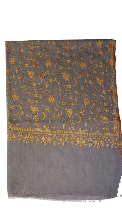 Luxuriously crafted and exquisitely detailed, this jaalidar pashmina stole stands as a statement of elegance and sophistication. At 70x200 cm and a mere 120 grams, it epitomizes luxury in every fiber. The stole, woven from the rare Yangir wool of the Himalayan Ibex, promises unparalleled softness. Its soft grey canvas, enriched with intricate yellow embroidery, reflects regal finesse and is a prized addition to any luxury collection. 